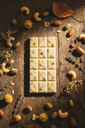 White chocolate bar with nuts in a 3-by-5 segment shape