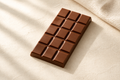 Amber Reserve by KoKo Huna milk chocolate bar on warm ivory stone with cocoa beans and linen